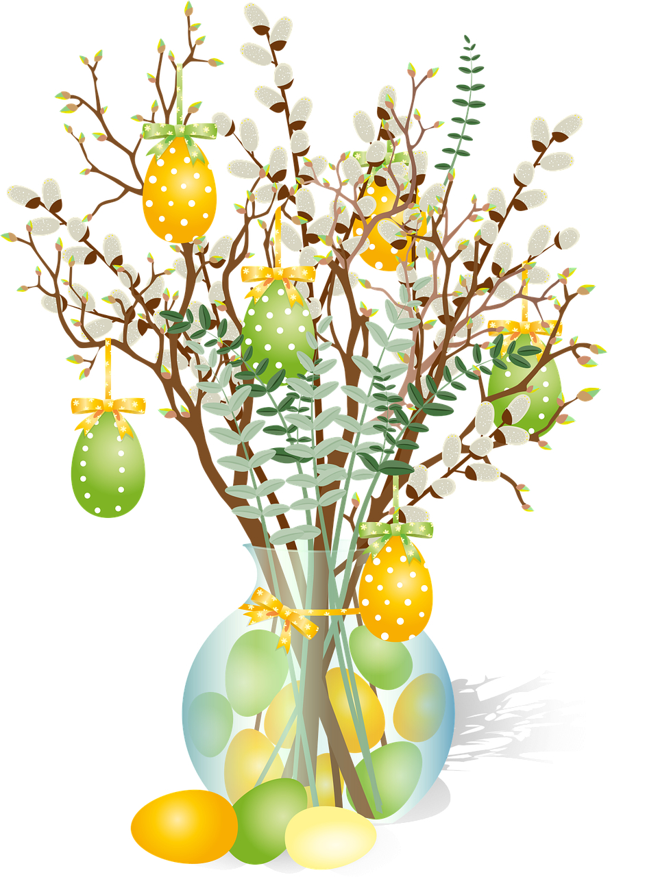 Stroik wielkanocny - gałązki z listkami i baziami w wazonie. Obok wazonu leżą i na gałązkach wiszą kolorowe jajka.
